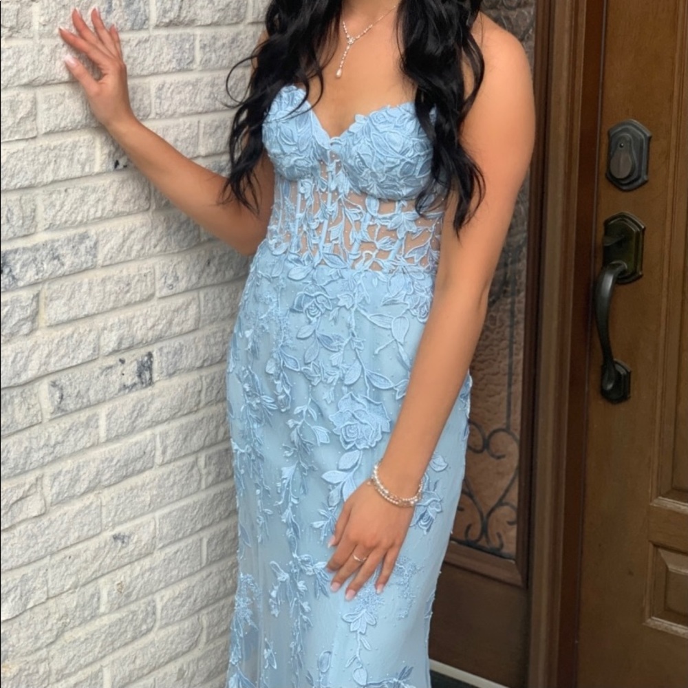 Stunning dress with lace appliqués and beading.